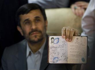 Iranian President Mahmoud Ahmadinejad holds up his identification as he waits to register as candidate for President of Iran in the Interior Ministry building in Tehran May 8, 2009. (Xinhua/Reuters Photo)