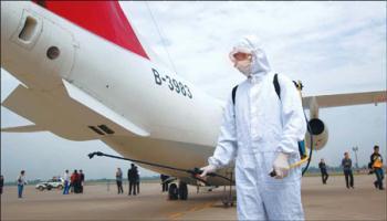 A medical worker sprays disinfectant liquid during a drill at Xianyang International Airport in Shaanxi province yesterday. [China Daily]