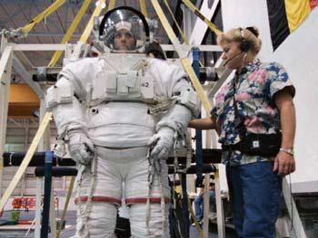 S99-05726 (26 May 1999) --- Astronaut Janet L. Kavandi, mission specialist, is about to be lowered into a deep pool for an underwater training session. The training took place at the Johnson Space Center's Neutral Buoyancy Laboratory (NBL), part of the Sonny Carter Training Center. Kavandi has weights on the training version of her extravehicular mobility unit (EMU) which help to provide neutral buoyancy in the pool. Astronauts Kavandi and Gerhard P.J. Thiele were participating in a rehearsal of a contingency space walk for the STS-99 mission.