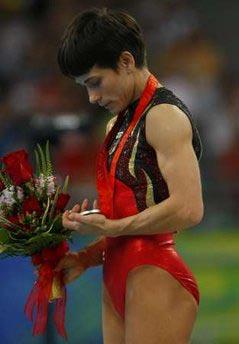 Silver medallist Oksana Chusovitina of Germany looks at her medal during the medal presentation ceremony for the gymnastics women's vault final at the Beijing 2008 Olympic Games.