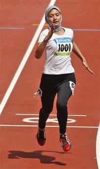 Robina Muqimyar of Afghanistan competes in the women's 100m heats during the athletics competitions in the National Stadium at the Beijing 2008 Olympics in Beijing, Saturday, Aug. 16, 2008. Muqimyar — who in 2004 broke the gender barrier on the Afghan Olympic team — was last in a field of 85 in the women's 100 meters in a time of 14.80, posted while running with a scarf covering her head.(AP Photo/Kevin Frayer) 