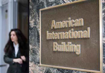 A woman exits the American International Building, world headquarters of American International Group (AIG) in New York, September 16, 2008, the United States. The Federal Reserve announced an 85 billion rescue loan to insurance giant American International Group (AIG).(Xinhua Photo)