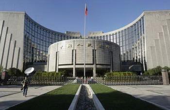 A woman walks in front of the headquarters of China's central bank, the People's Bank of China, in Beijing in this file photo dated October 8, 2008. The central bank decided to reduce the interest rate by a massive 1.08 per cent from Thursday, in a desperate effort to jumpstart capital investments, boost housing sale and propel domestic consumption, amid an increasing chilly economic winter of the world.[Agencies]