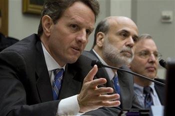 Treasury Secretary Timothy Geithner, left, accompanied by Federal Reserve Chairman Ben Bernanke, center, and William Dudley president and chief executive officer of the Federal Reserve Bank of New York William Dudley, testifies on Capitol Hill in Washington, Tuesday, March 24, 2009, before a House Financial Services Committee hearing on AIG.(AP Photo/Evan Vucci) 