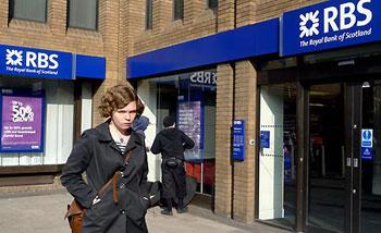 File photo taken on March 21, 2009 shows a woman walking past a branch of the Royal Bank of Scotland (RBS) in London, Britain. RBS said on April 7 that it might cut up to 9,000 jobs over the next two years, including 4,500 in the UK, in order to reduce cost. (Xinhua Photo)