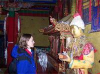 Katy exchanges glances with a holy statue at Yubulakang Palace