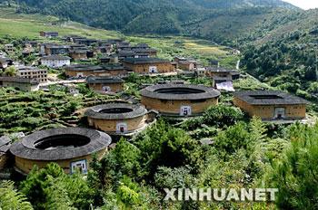 Tulou, the unique residential architecture of Fujian Province in southeastern China is inscribed on the UNESCO's World Heritage List Sunday during the 32nd session of the World Heritage Committee that is taking place in this eastern Canadian city Quebec. The photo is taken in October, 2002. [File Photo: Xinhua]