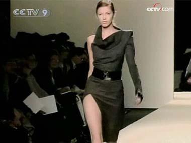 Models paraded down the catwalk in structured, futuristic garments, mostly in black. 