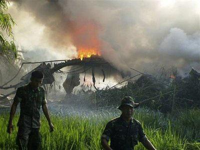 Fire razes through an Indonesian Air Force C-130 cargo plane after it crashed in Magetan, East Java, Indonesia, Wednesday, May 20, 2009.(AP Photo/detikSurabaya.com)