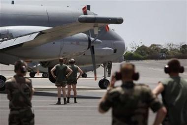 Members of the ground crew look on as an Atlantic Model 2 aircraft arrives at France's air base in Dakar, Senegal, from a mission seeking the site of the crash of a missing Air France flight Tuesday, June 2, 2009.(AP Photo/Rebecca Blackwell)