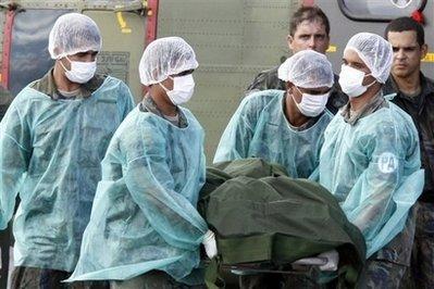 Crew members of a Brazilian Air Force Super Puma helicopter unload corpses of Air France airflight 447 passengers upon arrival at the Fernando de Noronha airport on June 11, 2009. Eleven of the 50 bodies recovered from an Air France jet that plunged into the Atlantic three weeks ago have been identified by fingerprints and dental records, Brazilian officials said Sunday.(AFP/File/Evaristo Sa)