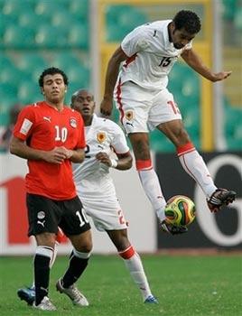 Angola's Rui Marques, right, controls the ball as teammate Marco Airosa, center, and Egypt's Emad Moteab, left, look on during their African Cup of Nations quarterfinal match in Kumasi, Ghana, Monday, Feb. 4, 2008. Egypt beat Angola 2-1 to advance to the semifinals.(AP Photo/Rebecca Blackwell) 