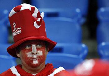 A Swiss fan reacts after the Euro 2008 Group A football match between Turkey and Switzerland in Basel, Switzerland, June 11, 2008. Turkey won 2-1. (Xinhua Photo)