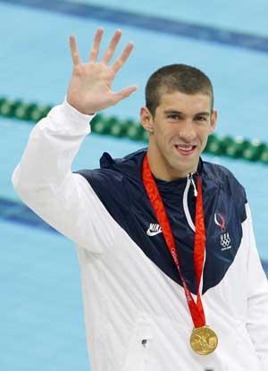 Michael Phelps of the United States reacts during the awarding ceremony of the men’s 400m individual medley at the Beijing 2008 Olympic Games in the National Aquatics Center, also known as the Water Cube in Beijing, China, Aug. 10, 2008. Phelps set a new world record and won the gold medal in the event with 4 minutes 3.84 seconds. (Xinhua/Fan Jun) (Xinhua Photo)