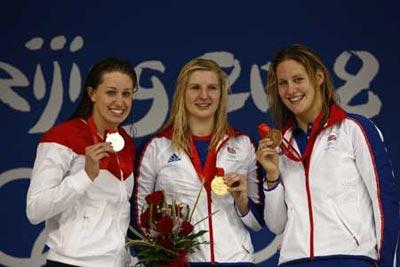 Winner Rebecca Adlington (C) of Great Britain with her teammate, bronze medalist Joanne Jackson (R)and runner-up Katie Hoff of the United States pose for photos on the podium during the awarding ceremony of women's 400m freestyle at the Beijing 2008 Olympic Games in the National Aquatics Center, also known as the Water Cube in Beijing, China, Aug. 11, 2008. (Xinhua)