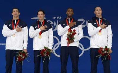 U.S. swimmers Michael Phelps，Weber-Gale，Cullen Jones and Jason Lezak (L to R) listen to their national anthem during the awarding ceremony of men's 4X100m freestyle relay at the Beijing 2008 Olympic Games in the National Aquatics Center, also known as the Water Cube in Beijing, China, Aug. 11, 2008. The United States set a new world record and won the gold medal in the event with 3 minutes 8.24 seconds. (Xinhua)