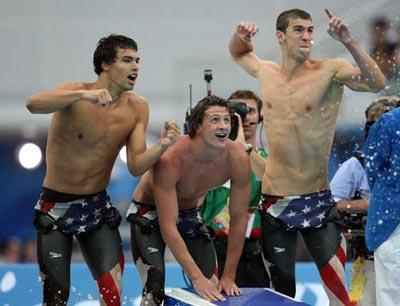 (L-R) Ricky Berens, Ryan Lochte and Michael Phelps of the United States shout encouragement to Peter Vanderkaay (Photo credit: Nick Laham/Getty Images)