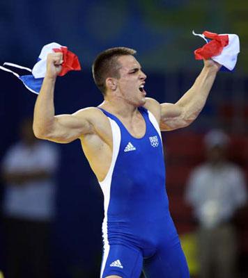 Steeve Guenot of France in blue celebrates during the men's Greco-Roman 66kg final of wrestling against Kanatbek Begaliev of Kyrgyzstan in red at Beijing 2008 Olympic Games in Beijing, China, Aug. 13, 2008. Steeve Guenot of France won the gold medal in the match.(Xinhua Photo/Lu Mingxiang)