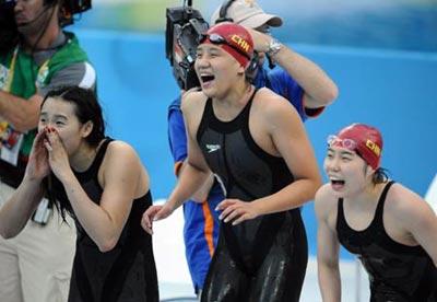 Tan Miao, Zhu Qianwei and Yang Yu (from R to L) of Chinese team cheer up for their teammate during the final of women's 4x200m freestyle relay at the Beijing 2008 Olympic Games in the National Aquatics Center, also known as the Water Cube in Beijing, China, Aug. 14, 2008. Chinese team won the silver medal with 7 minutes 45.93 seconds. (Xinhua Photo)