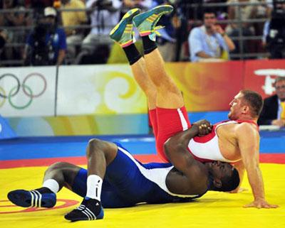 Mijain Lopez (blue) of Cuba wrestles with Khasan Baroev of Russia during the men’s Greco-Roman 120kg final at the Beijing 2008 Olympic Games wrestling event in Beijing, China, Aug. 14, 2008. Mijain Lopez won the bout and grabbed the gold medal. (Xinhua Photo)