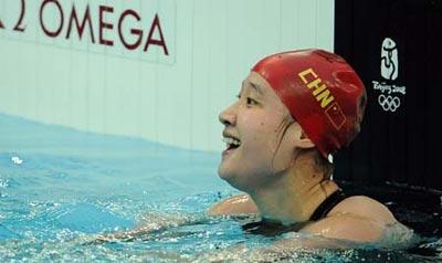 Liu Zige of China reacts during the final of women's 200m butterfly at the Beijing 2008 Olympic Games in the National Aquatics Center, also known as the Water Cube in Beijing, China, Aug. 14, 2008. Liu Zige won the gold medal with a new world record of 2 minutes 04.18 seconds. (Xinhua)