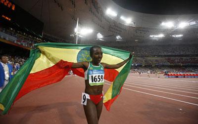 Tirunesh Dibaba of Ethiopia celebrates with a national flag after the final of women's 10000 meters at the National Stadium, also known as the Bird's Nest, at the Beijing 2008 Olympic Games in Beijing, China, Aug. 15, 2008. Tirunesh Dibaba claimed the title with 29 mins 54.66 secs. (Xinhua/Liao Yujie)