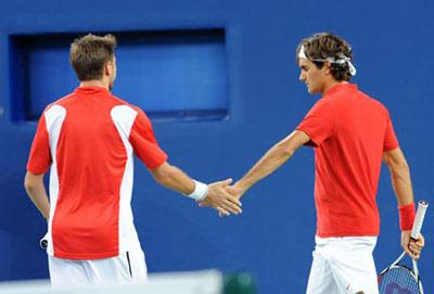 Roger Federer and Stanislas Wawrinka of Switzerland compete during the men's doubles gold medal match of Beijing Olympic Games tennis event against Simon Aspelin and Thomas Johansson of Sweden in Beijing, China, Aug. 16, 2008. (Xinhua Photo)