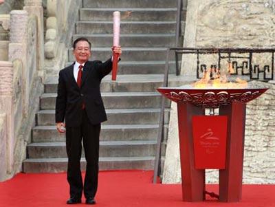 Chinese premier Wen Jiabao holds a torch after lighting the Beijing Paralympic flame during the Paralympic flame lighting ceremony at the ancient Temple of Heaven in Beijing, Aug. 28, 2008. (Xinhua)