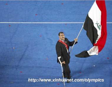 Powerlifting athlete Al-Ajeeli Faris carries the Iraqi national flag as he parades into the National Stadium during the opening ceremony of the Beijing 2008 Paralympic Games in Beijing, China, Sept. 6, 2008. (Xinhua photo)