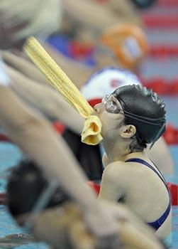 Jiang Fuying of China gets help by grabbing part of a towel  to start in the women's 100m backstroke S6 final at the National Aquatics Center during the 2008 Beijing Paralympic Games September 9, 2008.