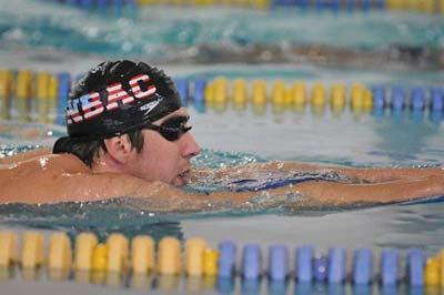 Olympic gold medalist Michael Phelps walks towards reporters to answer question before training at the Meadowbrook Aquatic Center, Friday, Feb. 6, 2009, in Baltimore. The swimming superstar has been suspended for three months and had his training stipend revoked by USA Swimming.(AP Photo/Gail Burton) 