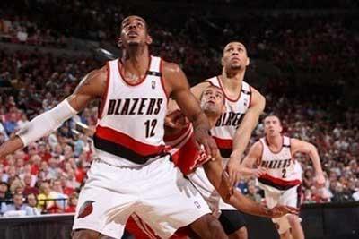 LaMarcus Aldridge (left) and Brandon Roy of the Portland Trail Blazers block out Shane Battier of the Houston Rockets at the Rose Garden Arena, on April 21, in Portland, Oregon. The Blazers won 107-103 to tie the best-of-seven- series 1-1.(AFP/NBAE/Getty Images/Sam Forencich) 