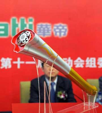 Photo taken on April 28, 2009 shows the torch named "Ruyi" for China's 11th National Games in Jinan, capital of east China's Shandong Province. Using the image of Chinese traditional ruyi, an s-shaped ornamental object which is usually made of jade and is a symbol of good luck, the torch made a debut in Jinan on Tuesday. (Xinhua/Fan Changguo) 