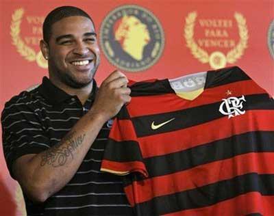 Brazilian soccer player Adriano holds up a Flamengo's jersey during a press conference in Rio de Janeiro, Thursday, May 7, 2009. Adriano was officially introduced by Flamengo, saying he regained his happiness in Brazil and assuring he didn't try to trick Inter Milan into releasing him after he deserted the Italian club.(AP Photo/ Ricardo Moraes) 