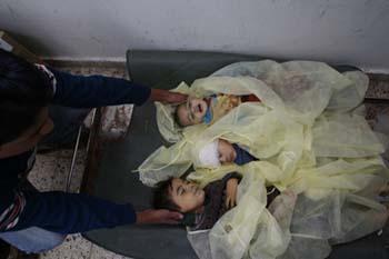 Bodies of three Palestinian children lay on a stretcher at Shifa hospital in the east of Gaza City after an Israeli strike on Jan.5, 2009.