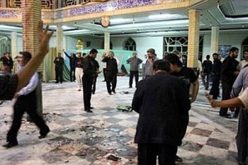 Iranian security personnel and civilians inspect the site of a bomb blast inside the Amir al-Momenin mosque in the southeastern Iranian city of Zahedan. The blast killed at least 19 worshippers and wounded 80 others, the official IRNA news agency reported.(AFP/IRNA/Mojtaba Goudarzi) 