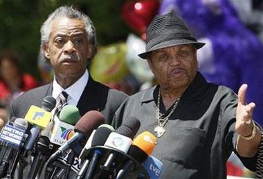 Rev. Al Sharpton and Joe Jackson, Michael Jackson's father, speak at a news conference in front of the the Jackson family residence in Encino, Calif., Monday, June 29, 2009. (AP Photo/Charles Dharapak)