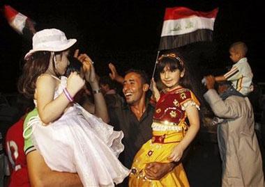 Iraqis celebrate in Basra, Iraq's second-largest city, 550 kilometers (340 miles) southeast of Baghdad, Iraq, Tuesday, June 30, 2009.(AP Photo/Nabil al-Jurani)