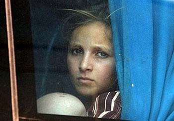 A Pakistani girl displaced by the military operation against the Taliban, looks out of a bus as she leaves to return home from the Jalozai Camp in Nowshera. Only a fraction of nearly two million Pakistanis displaced in an onslaught against the Taliban went home on the first day of an organised return Monday, with many fearful about security.(AFP photo)