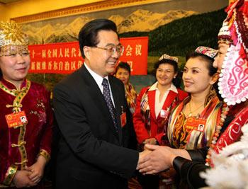 Chinese President Hu Jintao (2nd L) meets with deputies to the First Session of the 11th National People's Congress (NPC) from northwest China's Xinjiang Uygur Autonomous Region in Beijing, China, March 8, 2008. Hu Jintao joined in the panel discussion of Xinjiang delegation on Saturday during the First Session of the 11th NPC. (Xinhua Photo)