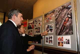 Chinese Ambassadress to Britain Fu Ying (R) shows photos about earthquake in China to British Prime Minister Gordon Brown at the Chinese Embassy in London, capital of Britain, May 20, 2008. Brown came to the Chinese Embassy on May 20 to offer condolences to Chinese quake victims. (Xinhua Photo)