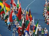 Flags of different delegations enter the field