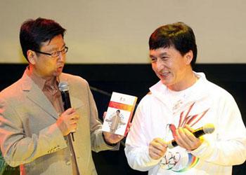 Jackie Chan (R), with China Central Television anchor Bai Yansong, promotes his album, one of the two solo albums authorized by the Beijing Olympics organizing committee, at the release ceremony in Beijing on August 7, 2008. [Photo: ent.sina.com.cn]