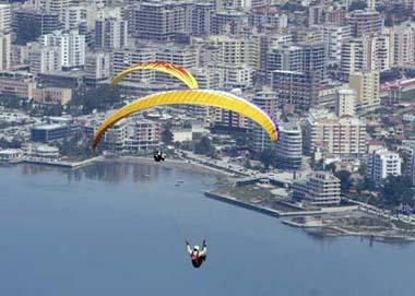 Paragliders fly over the city of Vlore during an annual Balkan competition, some 150 km (94 miles) from the capital Tirana, May 9, 2009.(Xinhua/Reuters Photo)