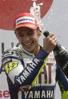 Valentino Rossi of Italy reacts on the podium after winning the MotoGP race and his 100th GP victory in Assen, northern Netherlands, Saturday June 27, 2009. (AP Photo/Bas Czerwinski) 