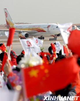 A chartered Air China plane carrying the Beijing Olympic flame touched down at the Beijing Airport Monday morning.