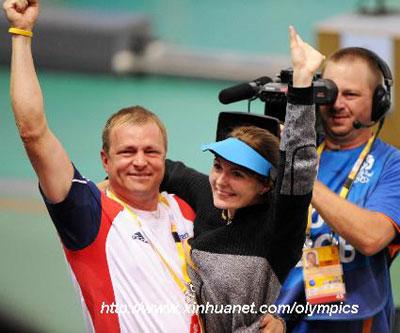 Markswoman Katerina Emmons (C) of Czech celebrates with her coach after women's 10m Air rifle final of Beijing Olympic Games at Beijing Shooting Range Hall in Beijing, China, Aug. 9, 2008. (Xinhua/Li Ga)
