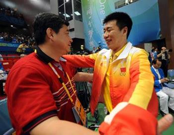 Pang Wei (R) of China celebrates with his coach Wang Yifu after men's 10m air pistol final of Beijing Olympic Games at Beijing Shooting Range Hall in Beijing, China, Aug. 9, 2008. Pang Wei won the gold medal in men's 10m air pistol final. (Xinhua/Jiao Weiping) 