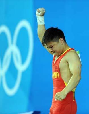 Long Qingquan of China celebrates after taking a successful snatch lift at the men's 56kg final of weightlifting at Beijing 2008 Olympic Games in Beijing, China, Aug. 10, 2008. Long claimed title in this event.(Xinhua Photo)