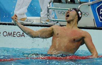 Kosuke Kitajima of Japan celebrates after winning the men's 100m breaststroke final at the Beijing 2008 Olympic Games in the National Aquatics Center, also known as the Water Cube in Beijing, China, Aug. 11, 2008. Kitajima set a new world record and won the gold medal in the event with 58.91 seconds.(Xinhua/Wang Dingchang) 